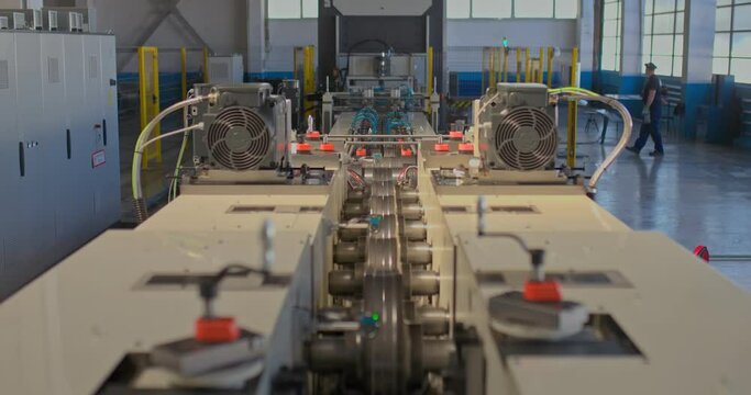 Large factory floor, conveyor installation. Metal processing plant, conveyor line.