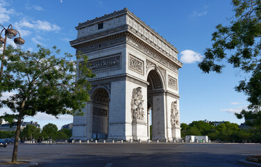 The famous Triumphal Arch at sunny day , Paris, France.