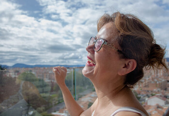Adult woman smiling with the sky in the background