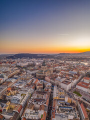 Aerial drone shot of east facade of St. Stephen's Basilica in Budapest sunrise morning glow