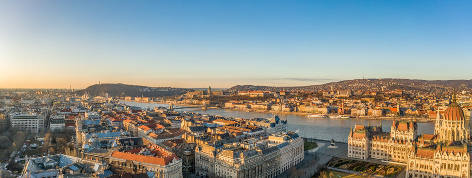 Panoramic aerial drone shot of Danube river with Buda castle and Hungarian Parliament in Budapest