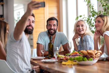 Friends take selfie while have lunch.