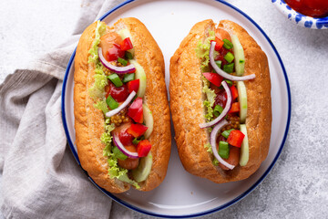 Hot dogs with sausage, sauces and vegetables