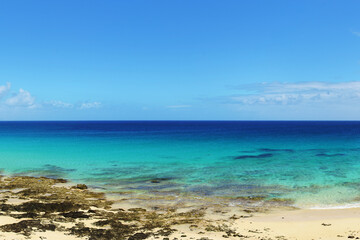 Tropical beach, azure ocean water and blue sky. Paradise landscape. Panorama