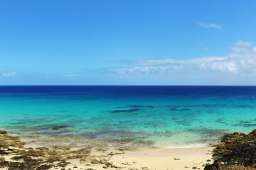 Tropical beach, azure ocean water and blue sky. Paradise landscape. Panorama