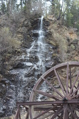 Wooden Wheel by Waterfall