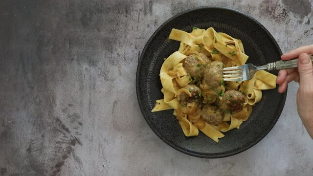 Eating Swedish Meatballs with Pappardelle Noodles