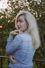 Portrait of a young beautiful blonde woman in the park.