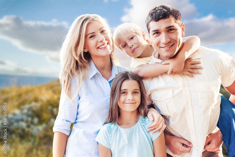 Poster Beautiful smiling lovely family on outdoor background