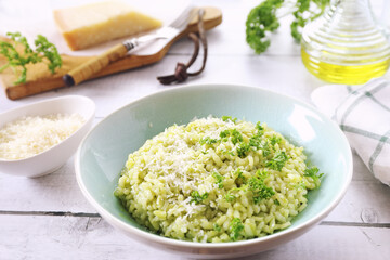 Italian cuisine. Plate of parsley risotto, olive oil and Parmesan cheese