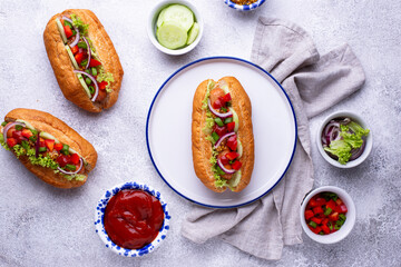 Hot dogs with sausage, sauces and vegetables