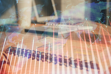 Double exposure of financial graph drawings and desk with open notebook background. Concept of forex market