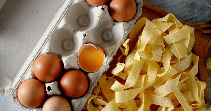 Dry fettuccine pasta with eggs slowly rotates.