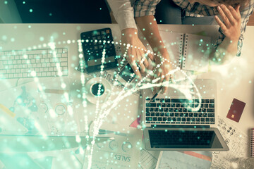 Double exposure of man and woman working together and DNA hologram drawing. Computer background. Medical education concept. Top View.