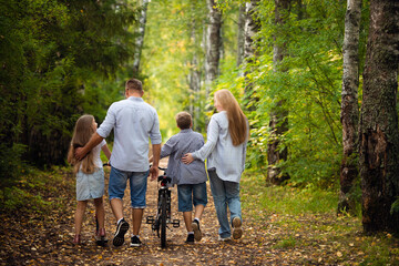 Happy family outdoors smiling in a summer forest - 361657192