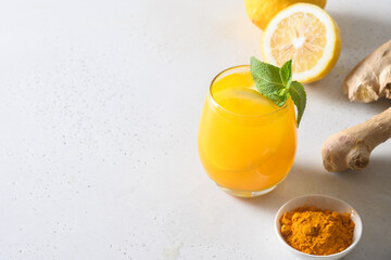 Jamu Indonesian herbal drink with turmeric, ginger on white background. Close up.