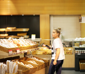 Woman choosing bread from a supermarket