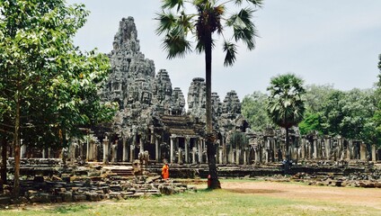 Cambodian Monk wandering the ancient temples of Angkor in Siem Reap Cambodia.