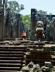 Beautiful ancient Buddha statue wrapped in orange robe in ancient Angkor Wat, Siem Reap Cambodia