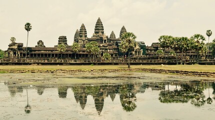 Fototapeta na wymiar Reflective panoramic lake shot of Angkor Wat, Siem Reap Cambodia. 8th wonder of the world but should be 1st.