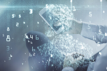 Double exposure of man's hand holding and using a digital device and data theme drawing. Technology concept.