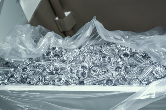PET preforms for blowing plastic bottles in factory.