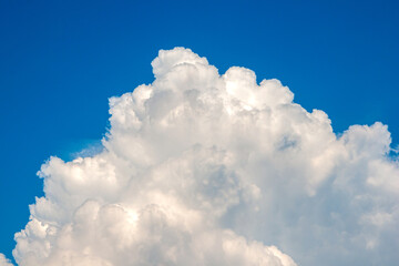 Naklejka na ściany i meble White cloud on a blue background. Horizontal photography.