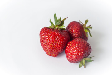 Eco or Bio Strawberry on White Background - Three Berries Composition Isolated Close up View Shot with Natural Light
