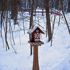 bird house in the park in winter under the snow