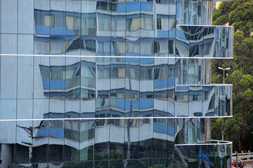 Building facade detail with mirrors reflecting another building
