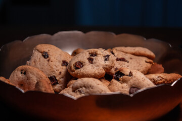 Homemade cookies with chocolate chips and raisins in a bowl