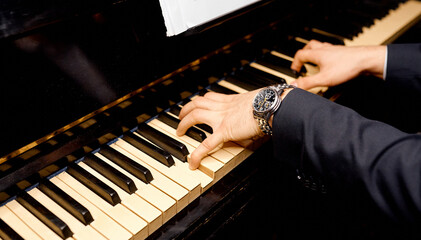 Fototapeta premium Man hands playing on a old piano . Detail, baroque.