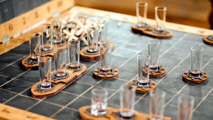 Fototapeta na wymiar alcoholic board game sea battle with stacks of glass glasses