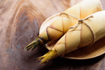 Raw bamboo shoot on wooden plate preparing for cooking, Organic plant	
