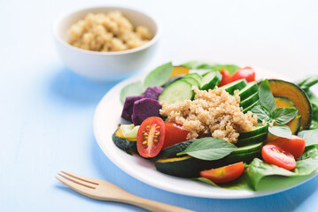 Salad quinoa with vegetables on plate, Vegan food