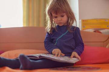 little girl reading a book