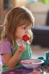 child eating strawberries