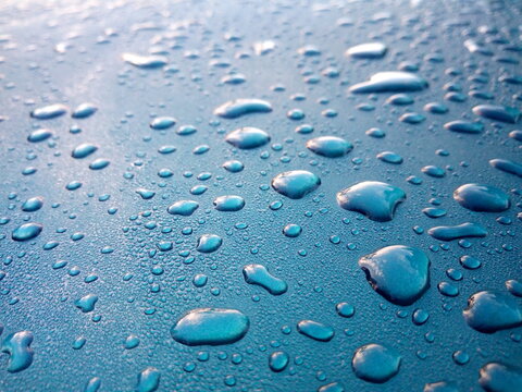 Dew drops on the roof of the blue car Use as background