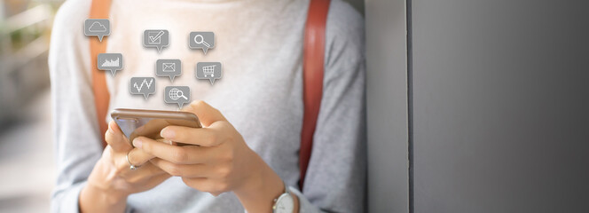 hand of woman holding smartphone with notification icons social media.