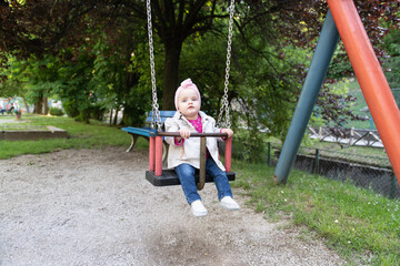 Child Swinging on Swing in a Park