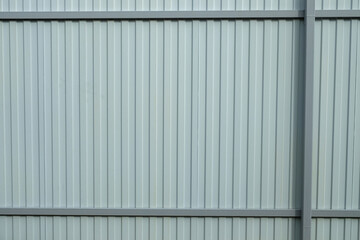 Gray corrugated metal fence. Part of the fence