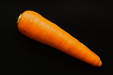 Carrot on a black background, close up.
