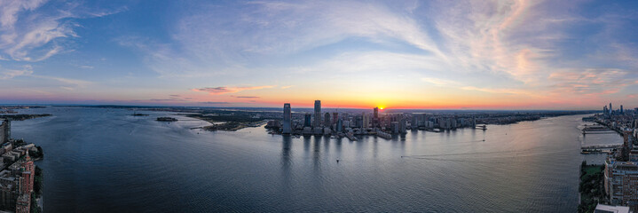 Panorama view of the Skyline of Jersey City in sunset day, New York City, United States. Shot from Hudson River 