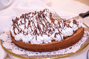 
chocolota cake with vanilla, strawberry and cre on event table