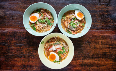 Tom Yam Thai with soft-boiled eggs comes in a small bowl.That has egg noodles, vermicelli and thin rice noodles...