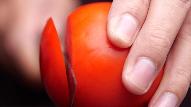 Close-up of slicing red tomato
