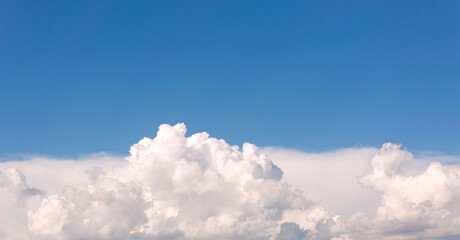 White clouds on blue sky background.
