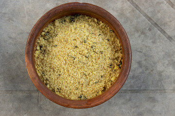 Handmade clay container with flour.