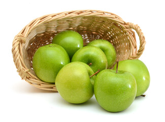 basket of green apples on white background