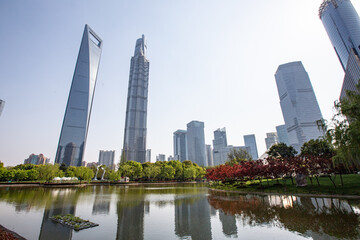 Fototapeta premium Central Park in Lujiazui, with a pond and a lawn in the middle of modern skyscrapers, in Shanghai, China.